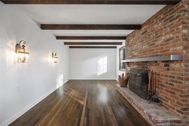 unfurnished living room featuring a fireplace, beam ceiling, and dark wood-type flooring