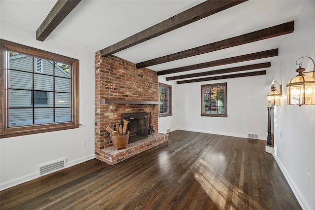 unfurnished living room featuring a brick fireplace, beam ceiling, and dark hardwood / wood-style floors