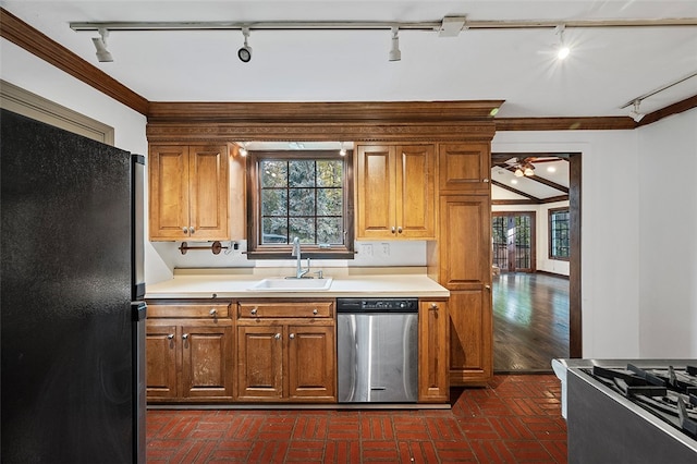 kitchen featuring black fridge, ornamental molding, sink, stainless steel dishwasher, and rail lighting