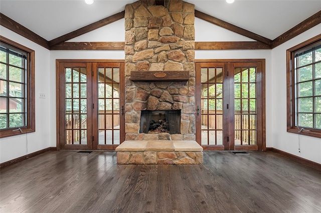 unfurnished living room featuring french doors, lofted ceiling with beams, and a healthy amount of sunlight