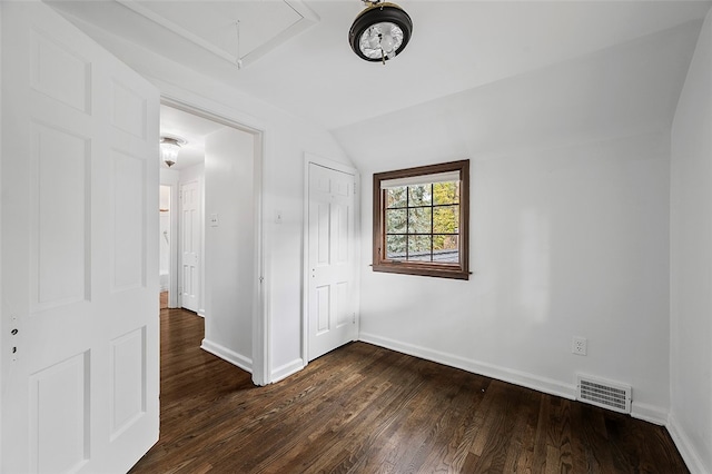 unfurnished bedroom with dark hardwood / wood-style floors and vaulted ceiling