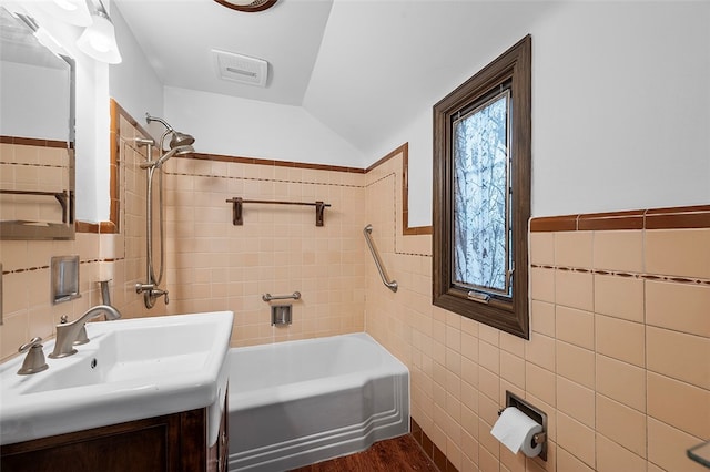 bathroom with vanity and tile walls