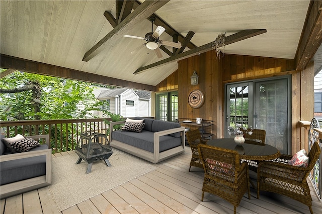 wooden deck with outdoor lounge area and ceiling fan