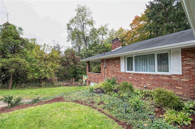 view of side of home with a lawn