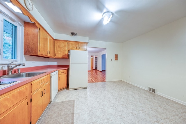 kitchen featuring white appliances and sink