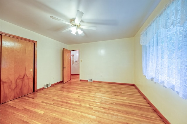 unfurnished bedroom with a closet, ceiling fan, and light wood-type flooring