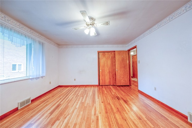 unfurnished bedroom with ornamental molding, light hardwood / wood-style flooring, and ceiling fan