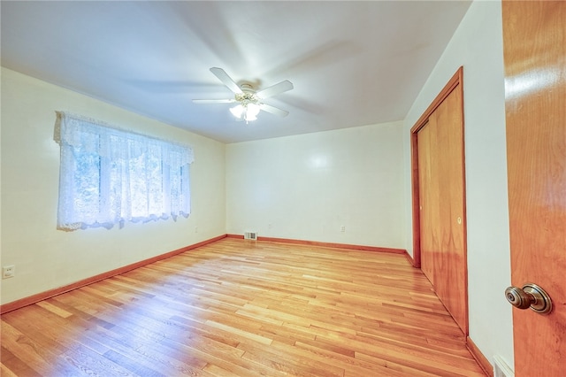 unfurnished room with light hardwood / wood-style floors and ceiling fan