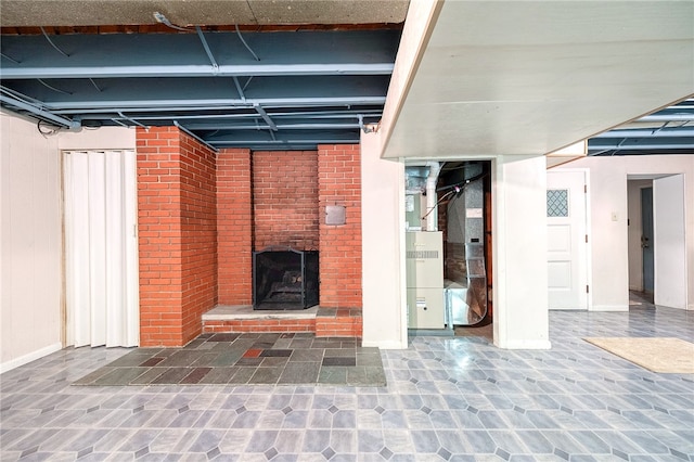 basement featuring a brick fireplace