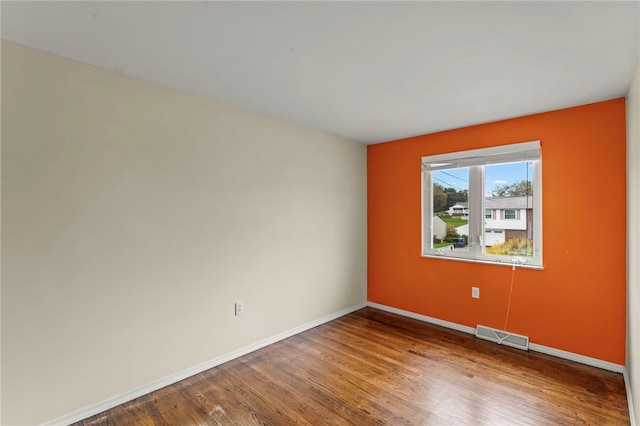 unfurnished room featuring hardwood / wood-style flooring