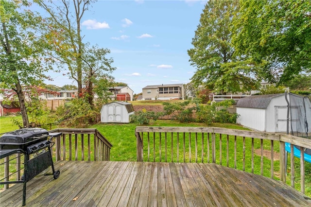 deck featuring a yard and a storage unit