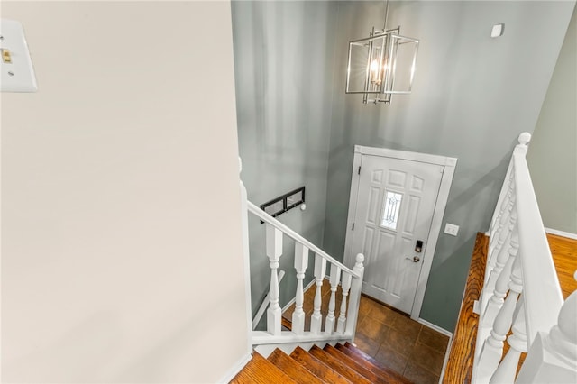 entryway featuring an inviting chandelier and dark hardwood / wood-style flooring