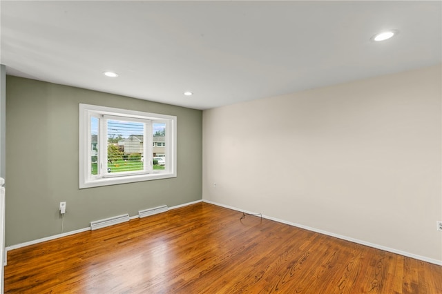 empty room with hardwood / wood-style flooring