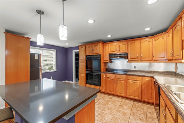 kitchen featuring a kitchen island, black appliances, sink, decorative light fixtures, and light tile patterned floors