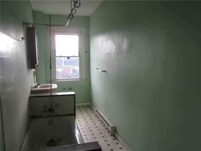 bathroom with vanity, baseboard heating, and shower / washtub combination