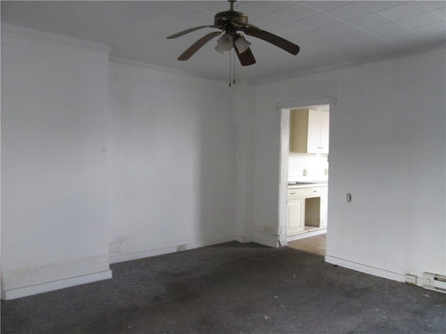 spare room featuring ceiling fan and ornamental molding