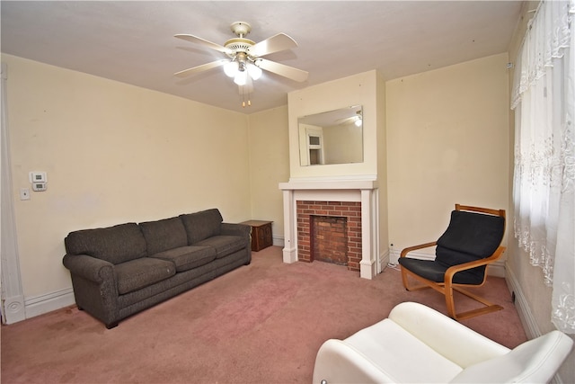 carpeted living room with a brick fireplace and ceiling fan