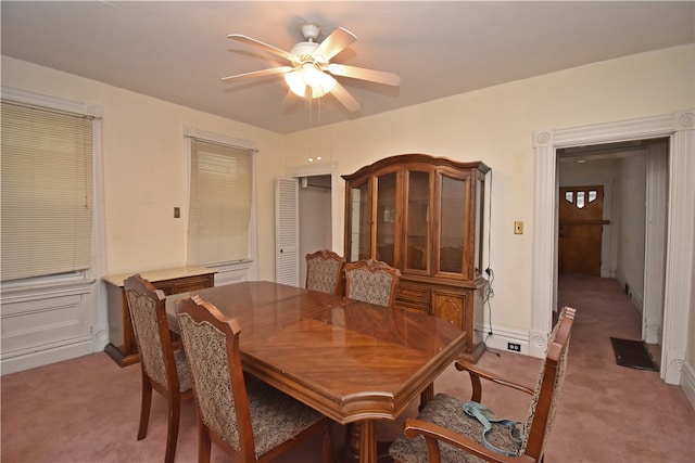 carpeted dining room with baseboard heating and ceiling fan