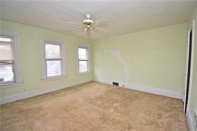 carpeted empty room featuring ceiling fan