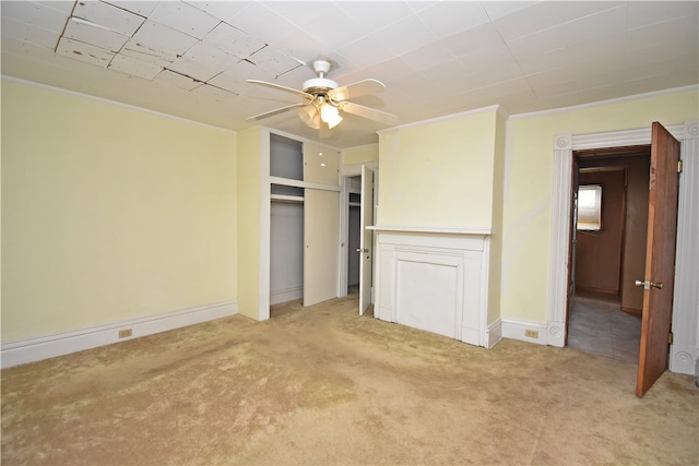 unfurnished bedroom with light carpet, crown molding, and ceiling fan