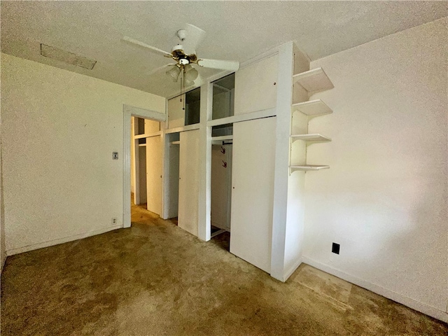 unfurnished bedroom featuring carpet floors, a textured ceiling, and ceiling fan