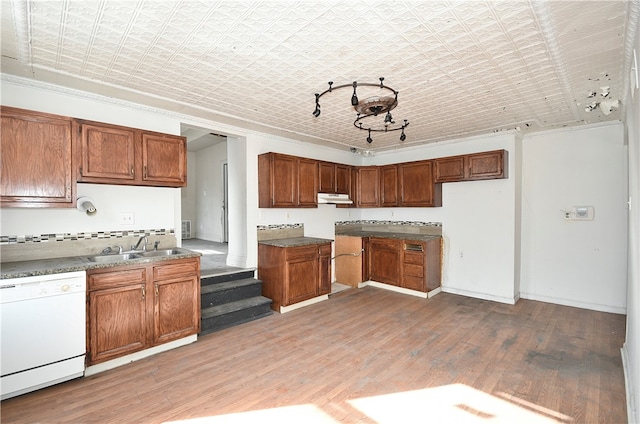 kitchen with sink, crown molding, light hardwood / wood-style flooring, and dishwasher