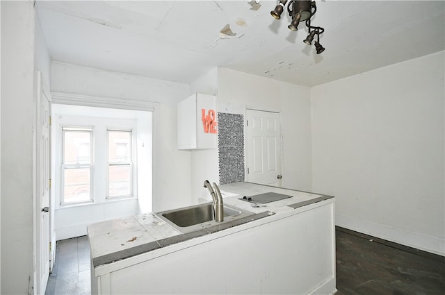 kitchen featuring sink, dark hardwood / wood-style floors, and white cabinets