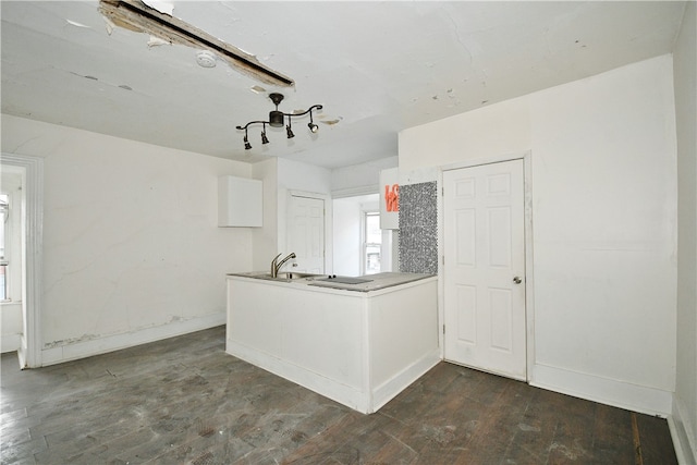 kitchen featuring white cabinets, dark hardwood / wood-style floors, and sink