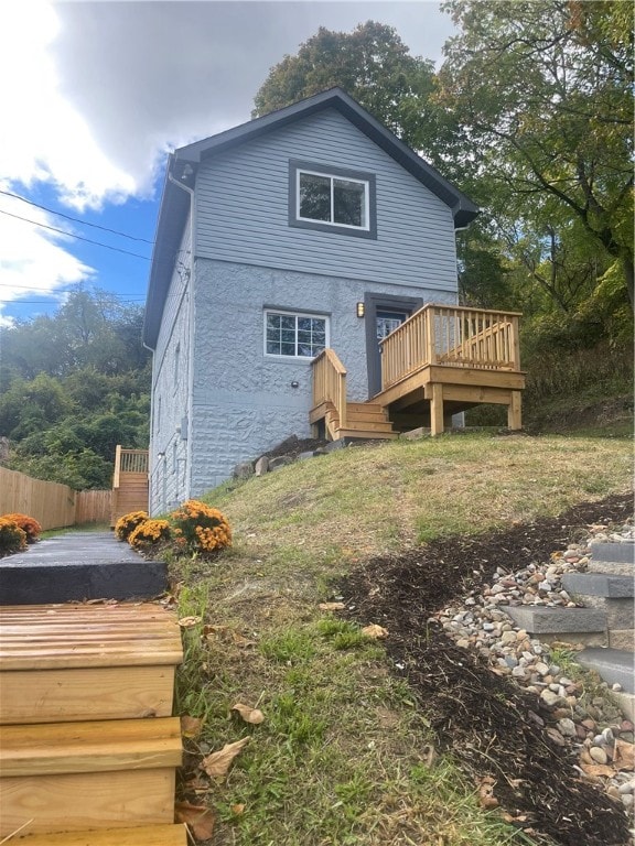 back of house with a wooden deck