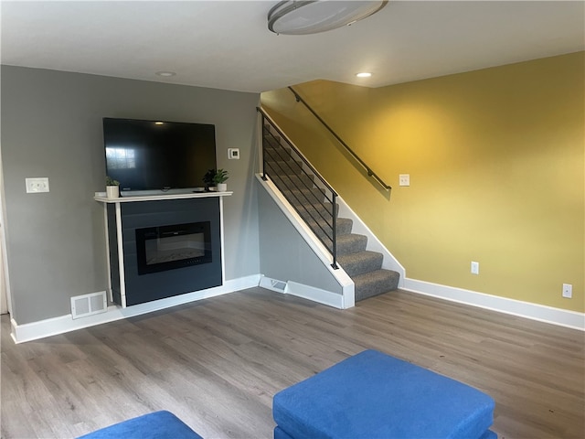 unfurnished living room featuring wood-type flooring