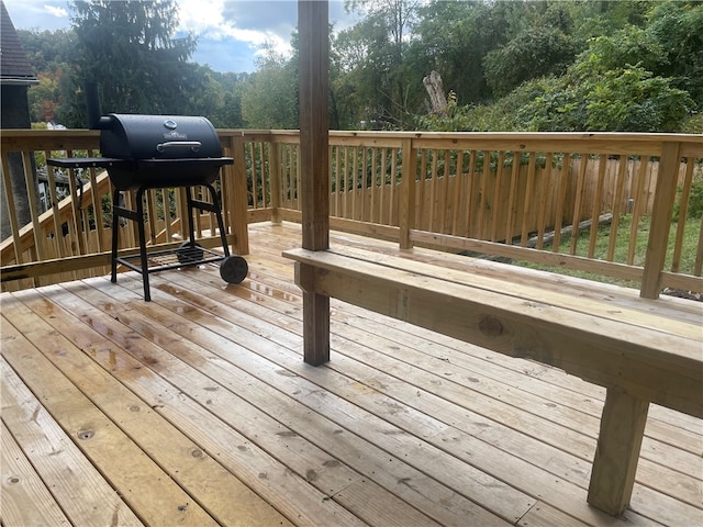 wooden deck featuring a grill