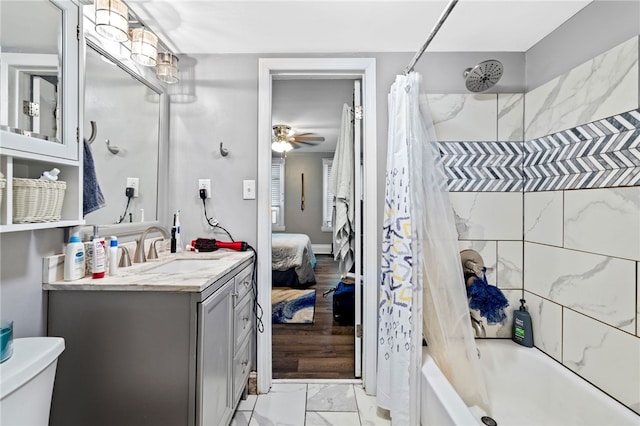 full bathroom with toilet, ceiling fan, shower / bath combo with shower curtain, and vanity