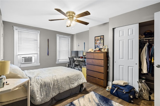 bedroom with ceiling fan, cooling unit, and hardwood / wood-style flooring