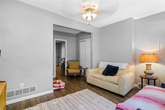 living room featuring dark hardwood / wood-style flooring and ceiling fan