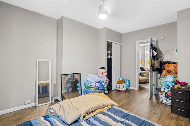 bedroom with wood-type flooring and a closet