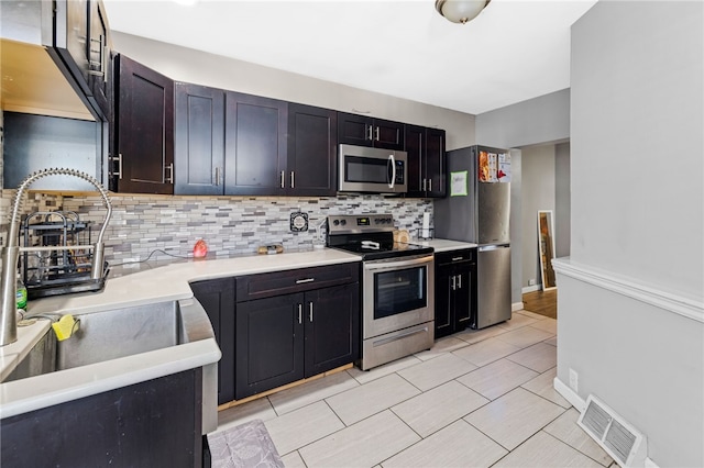 kitchen with appliances with stainless steel finishes and tasteful backsplash