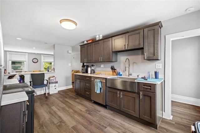 kitchen with dishwasher, dark wood-type flooring, sink, and dark brown cabinets