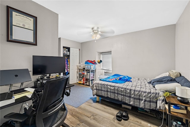 bedroom with wood-type flooring and ceiling fan