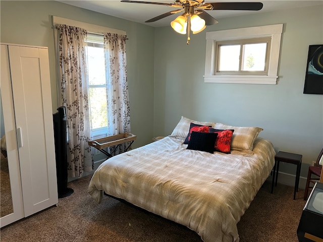 carpeted bedroom with multiple windows and ceiling fan