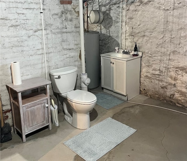 bathroom featuring vanity, concrete floors, gas water heater, and toilet