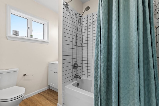 full bathroom featuring shower / bath combination with curtain, hardwood / wood-style floors, vanity, and toilet