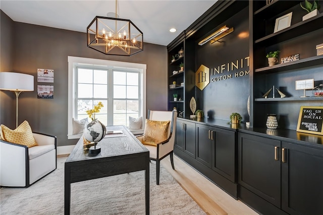 office space with built in shelves, a chandelier, and light hardwood / wood-style flooring