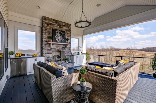 wooden deck with an outdoor living space with a fireplace