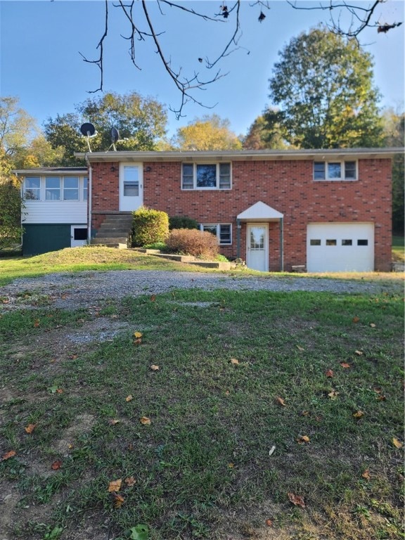 view of front of home with a front lawn and a garage