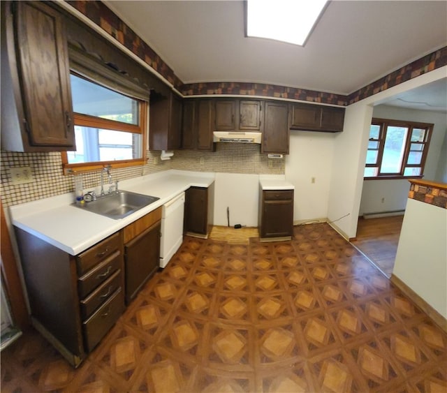 kitchen featuring tasteful backsplash, plenty of natural light, sink, and dishwasher