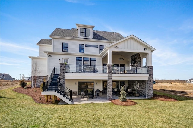 rear view of property featuring a lawn and a patio area