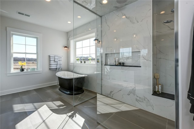 bathroom with plenty of natural light and shower with separate bathtub