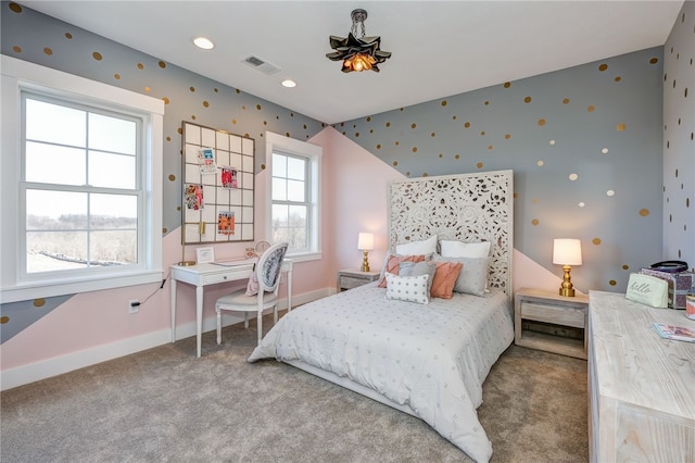 carpeted bedroom with multiple windows