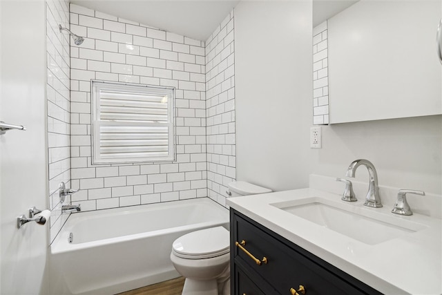 full bathroom featuring hardwood / wood-style flooring, vanity, toilet, and tiled shower / bath