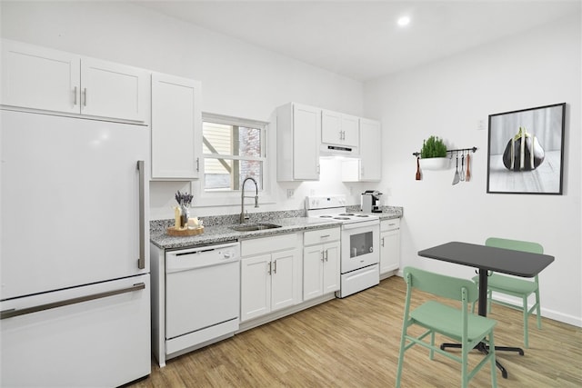 kitchen with light wood-type flooring, white appliances, sink, and white cabinets